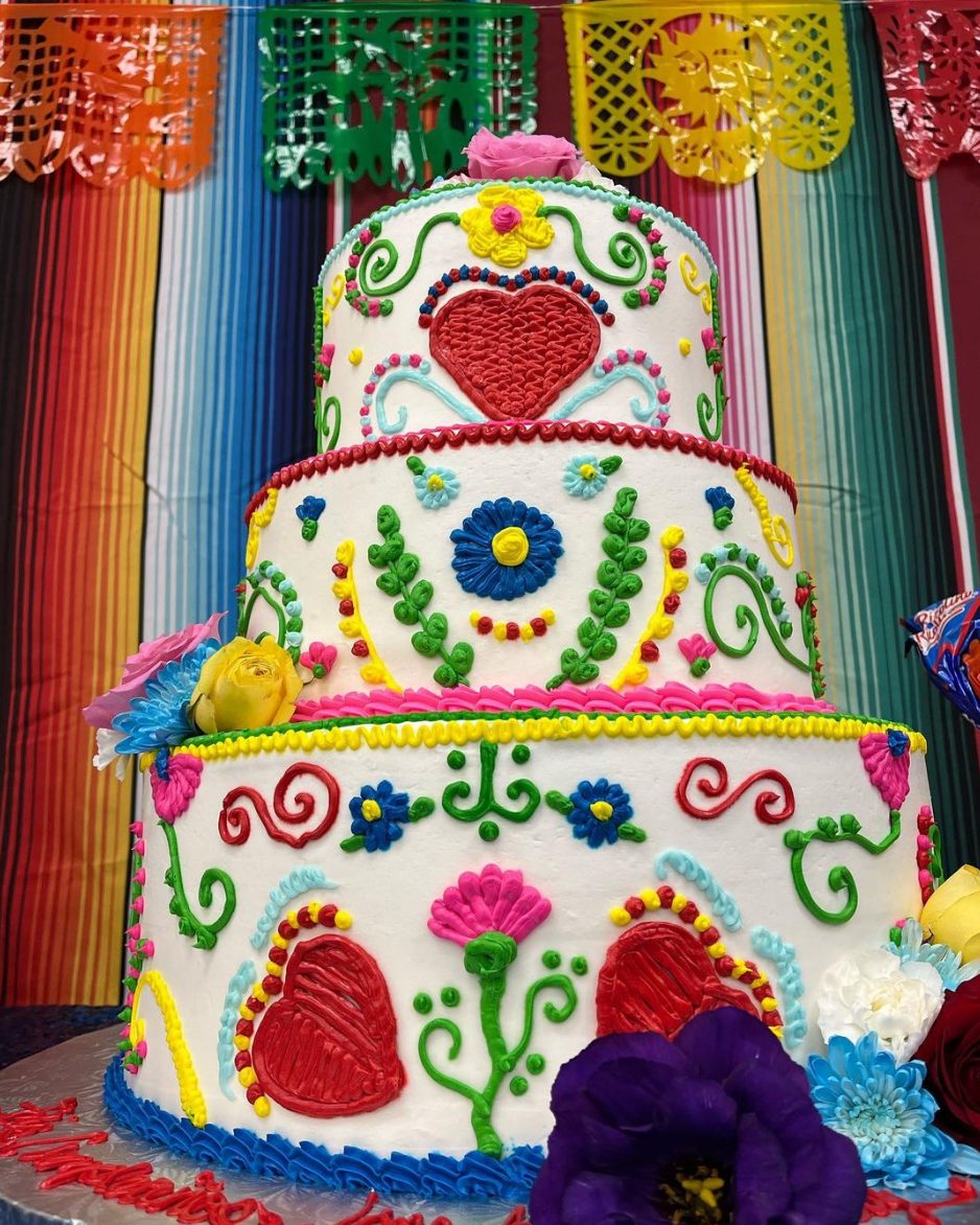 A three-tier cake piped with colorful Mexican folk-art designs